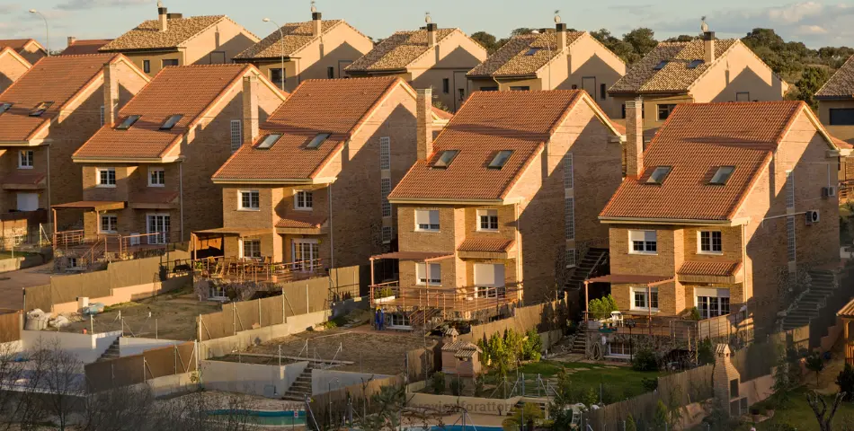 Rows of brick residential homes with tiled roofs in a neighborhood, representing liability and injuries on Airbnb properties