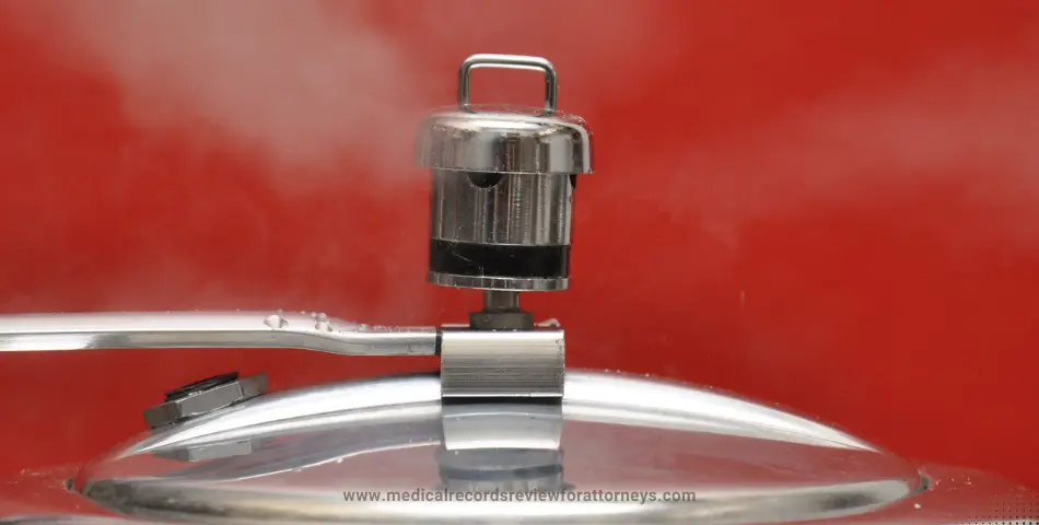 Metal pressure cooker lid releasing steam from valve against red background, illustrating cooker related injuries