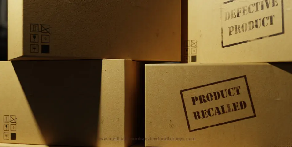 Stacked boxes stamped 'defective product' and 'product recalled' under warm lighting, illustrating defective product lawsuit