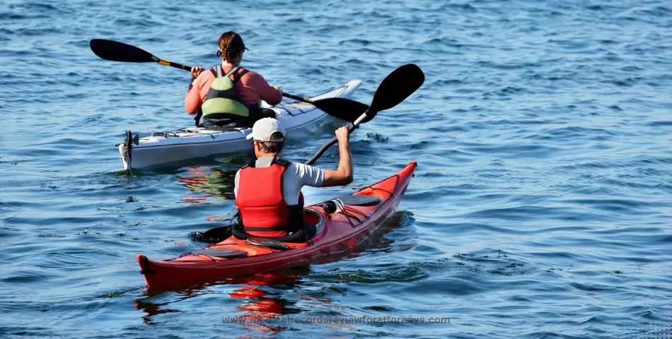 Man and woman kayaking on calm lake wearing life jackets and paddling, illustrating boating laws and safety
