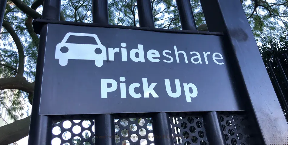 Rideshare pick up sign on a metal gate outdoors, representing rideshare assault cases and passenger safety legal claims