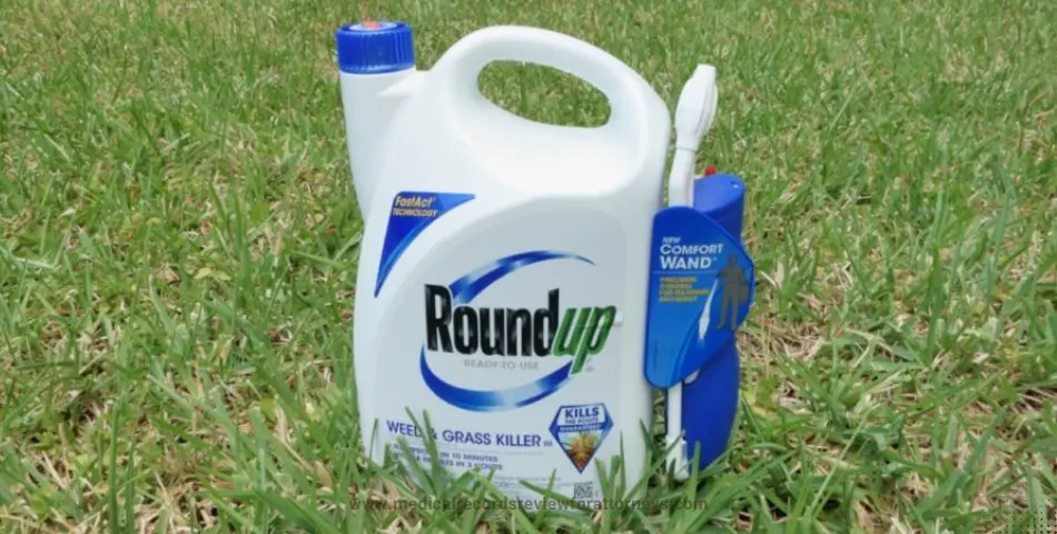 Roundup weed and grass killer bottle with comfort wand on a lawn, representing the Roundup class action lawsuit and cancer claims