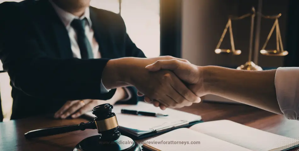 Two professionals shaking hands over desk with gavel representing legal settlement letter