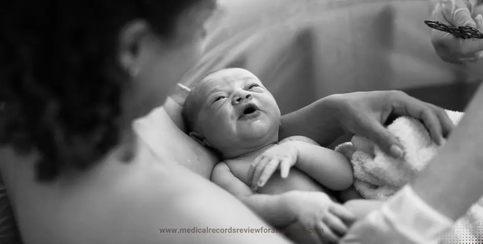 Mother tenderly holding her newborn baby wrapped in a soft blanket during a quiet moment represents birth trauma.